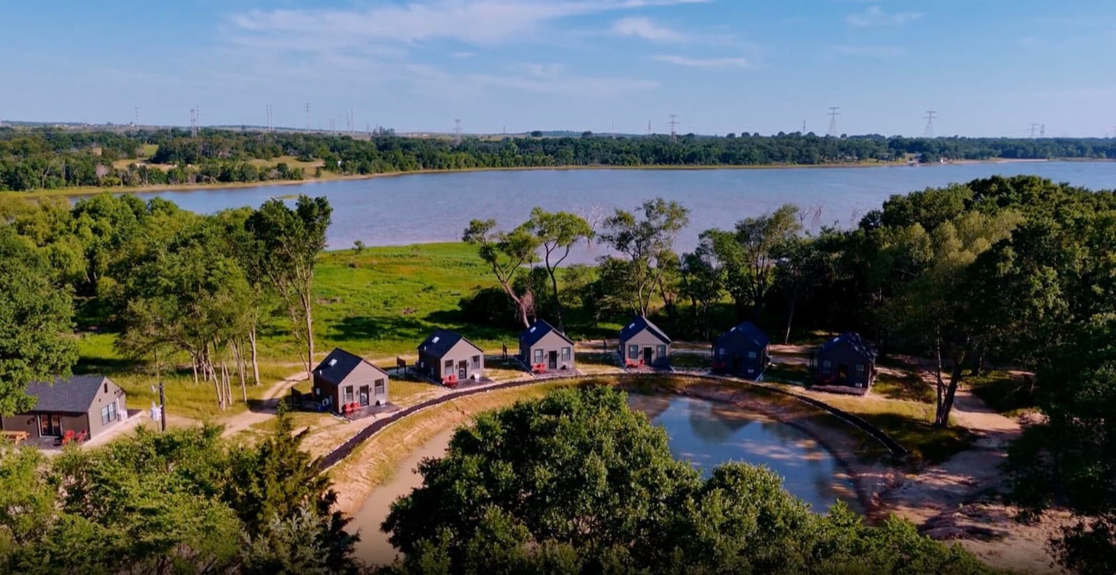Aerial view of a wooded cove on Lake Limestone with cabins at the water's edge