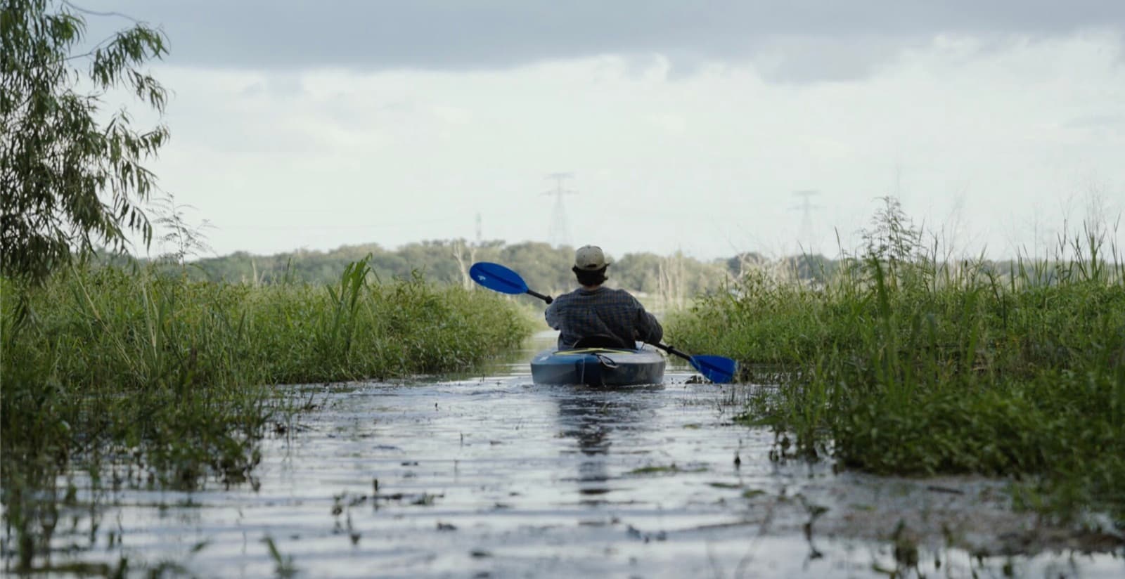 A kayak moving through tall marsh grass on Lake Limestone
