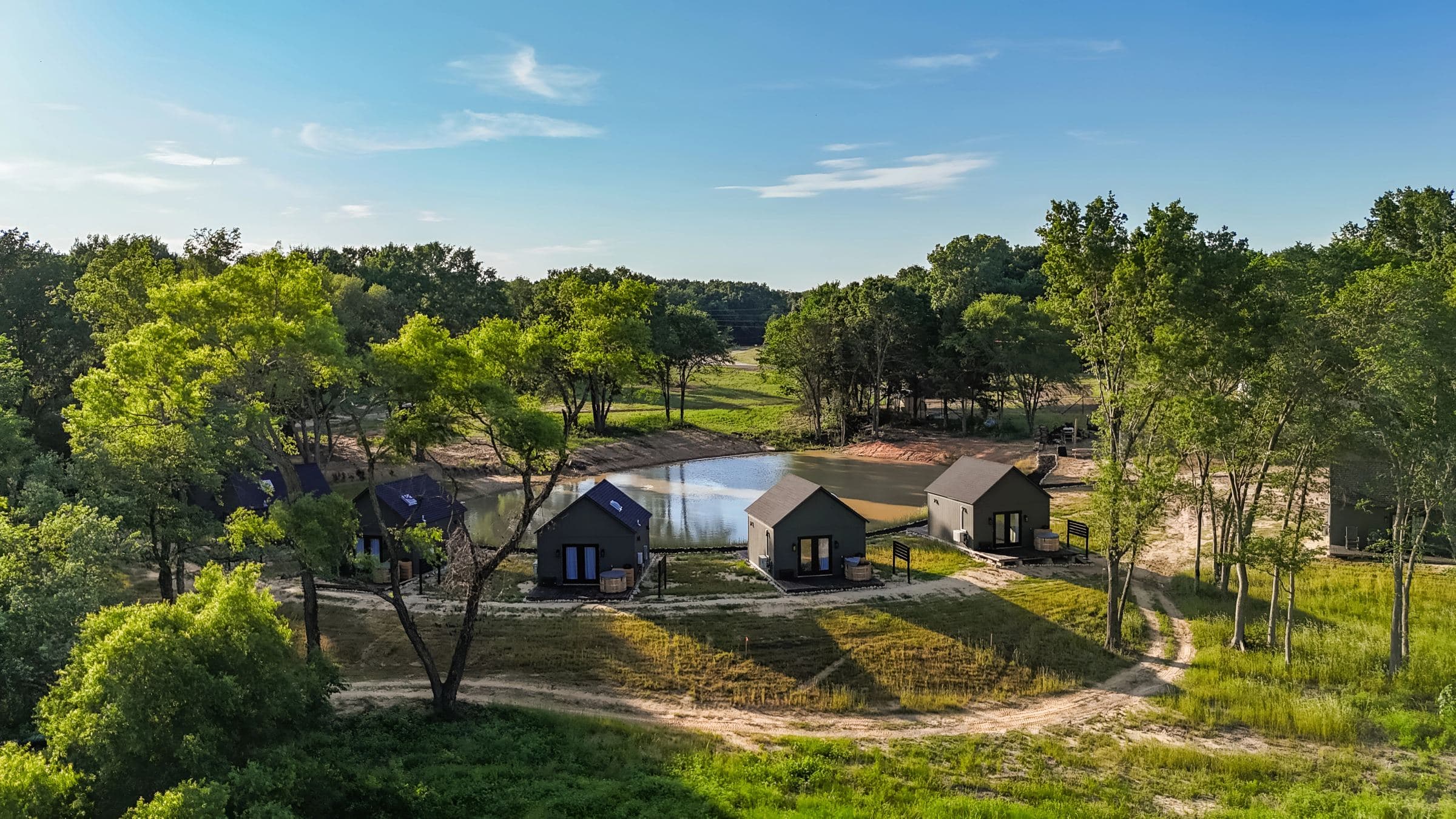 Aerial view of the cabins around the pond at Limestone Fields